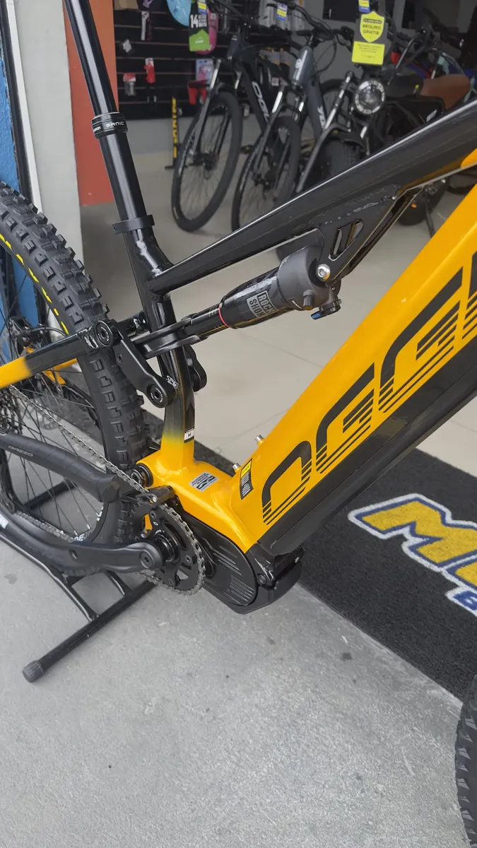 Vista traseira da Oggi Razzo T-130 mostrando quadro full suspension alumínio e cubo Shimano 148x12 Boost